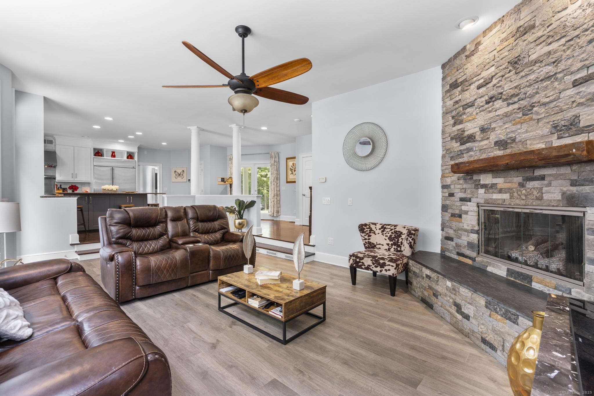 101 Brambly Hedge Circle Fairfield, CT 06824 - Photo 12 of 40 a living room with furniture and a fireplace