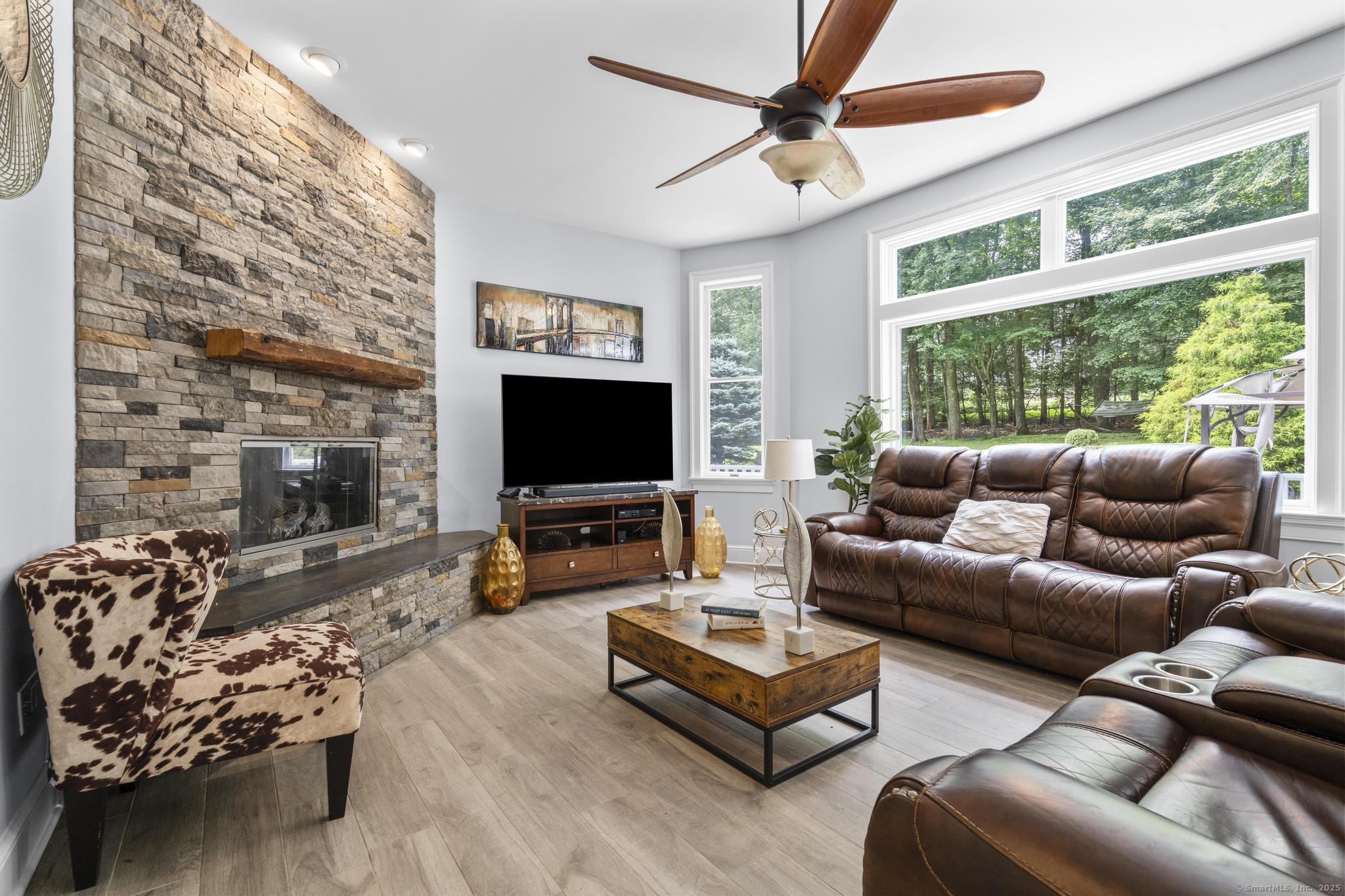 101 Brambly Hedge Circle Fairfield, CT 06824 - Photo 13 of 40 a living room with furniture a large window and a flat screen tv