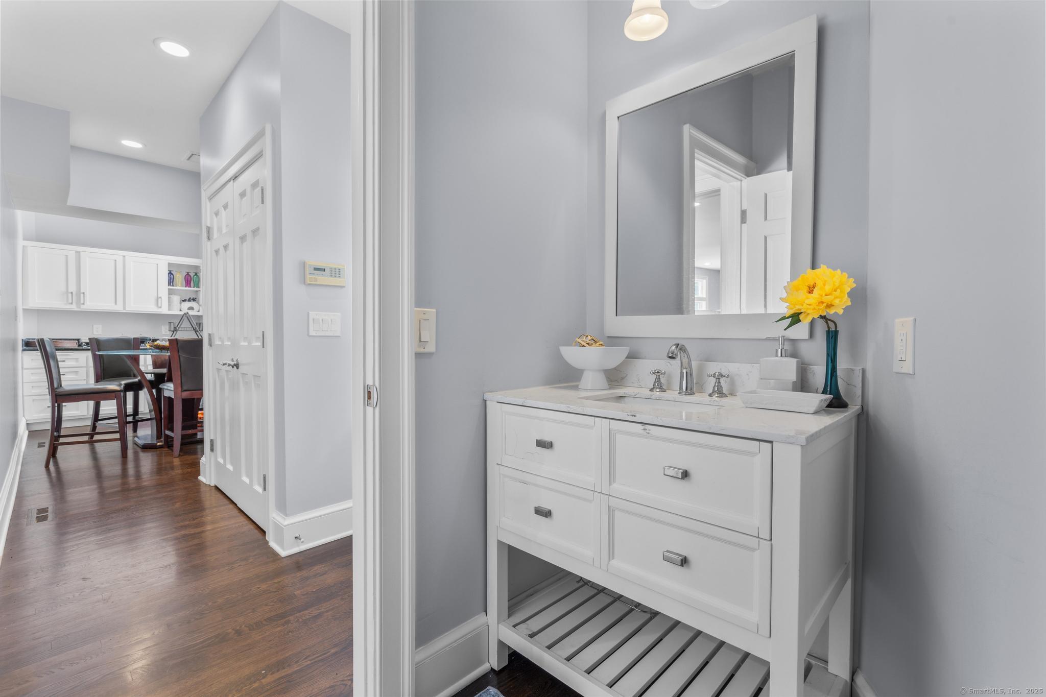 101 Brambly Hedge Circle Fairfield, CT 06824 - Photo 16 of 40 a bathroom with a granite countertop sink a vanity and a mirror