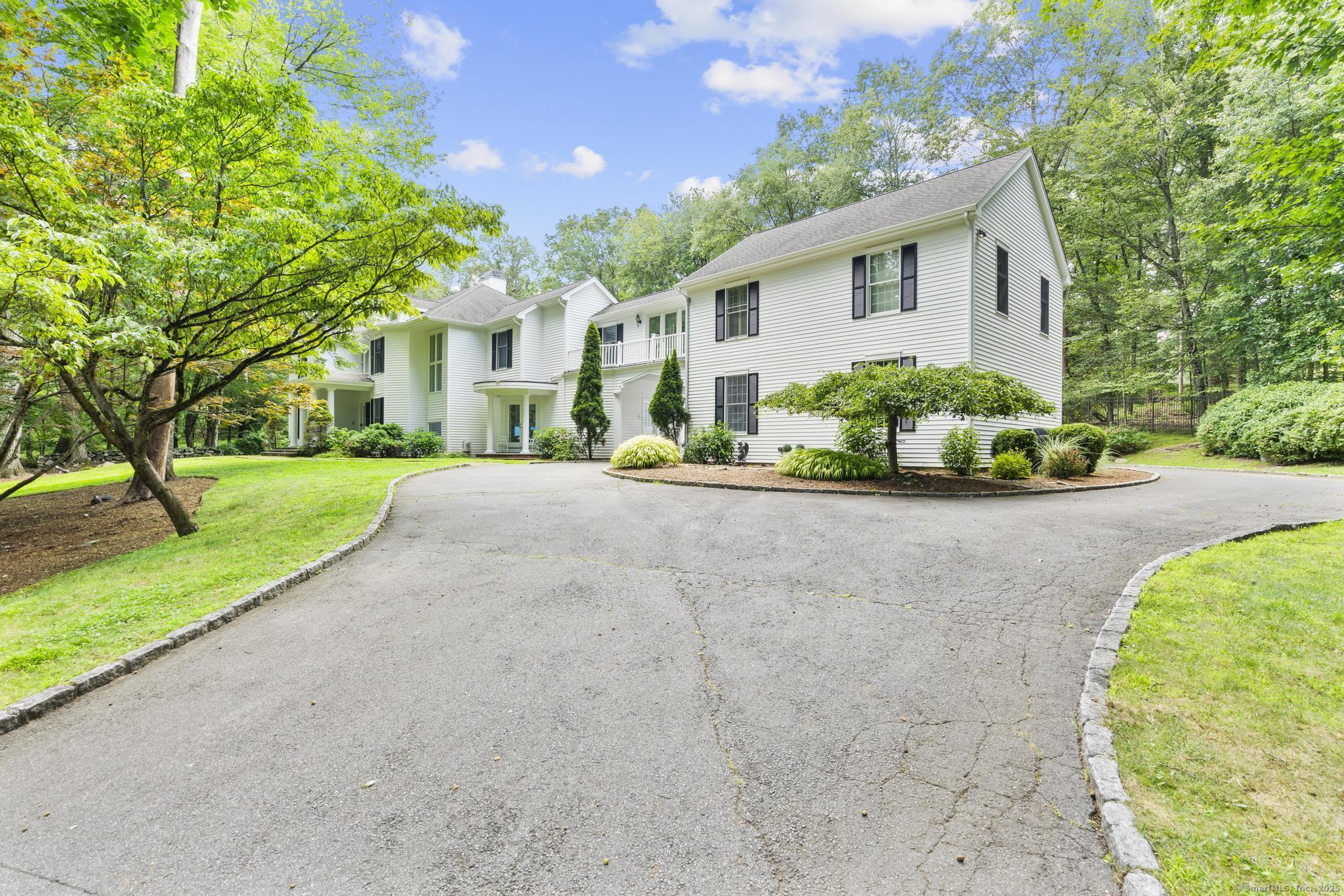 101 Brambly Hedge Circle Fairfield, CT 06824 - Photo 2 of 40 a front view of a house with a yard