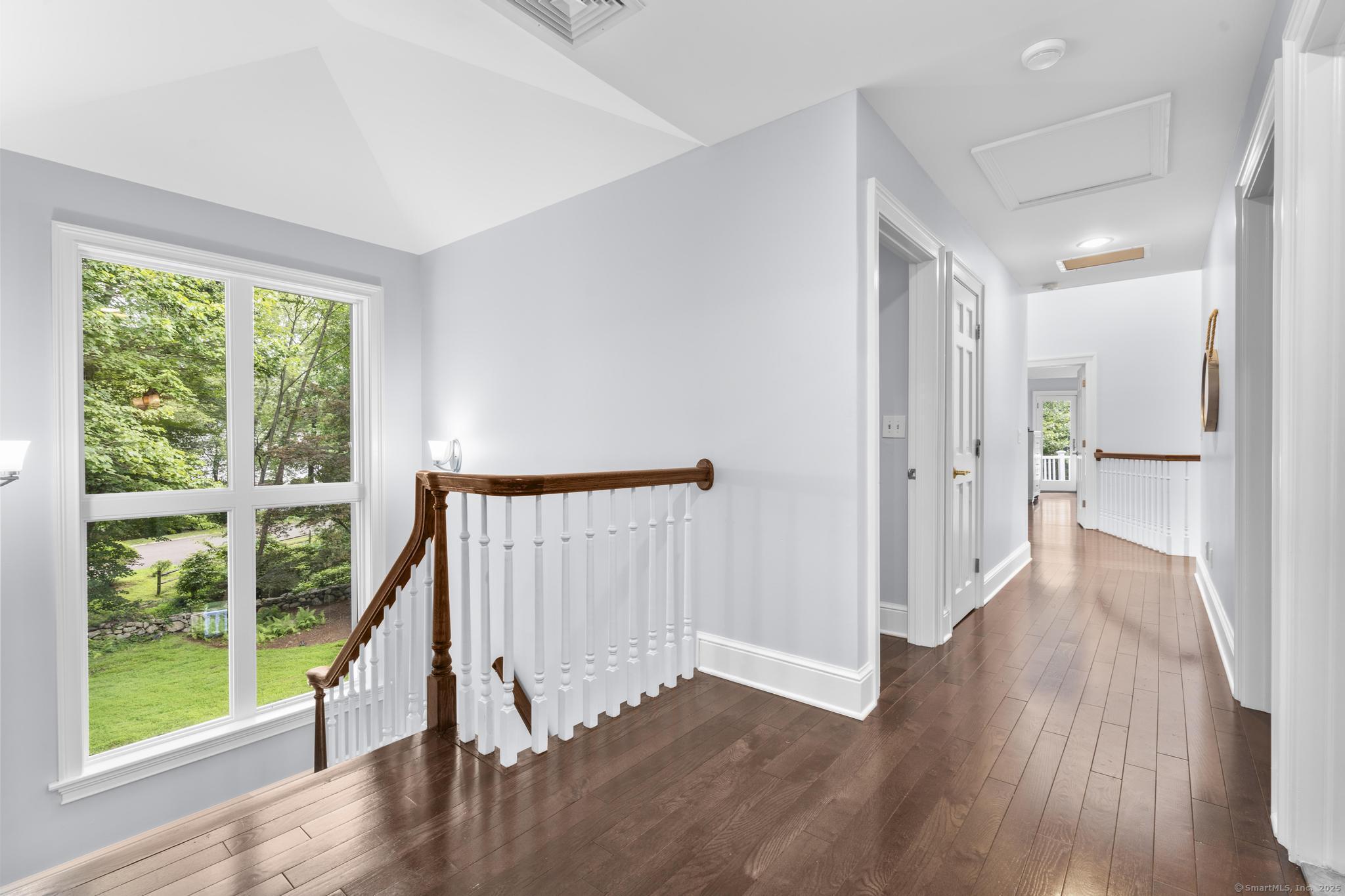 101 Brambly Hedge Circle Fairfield, CT 06824 - Photo 31 of 40 a view of a hallway with wooden floor and stairs