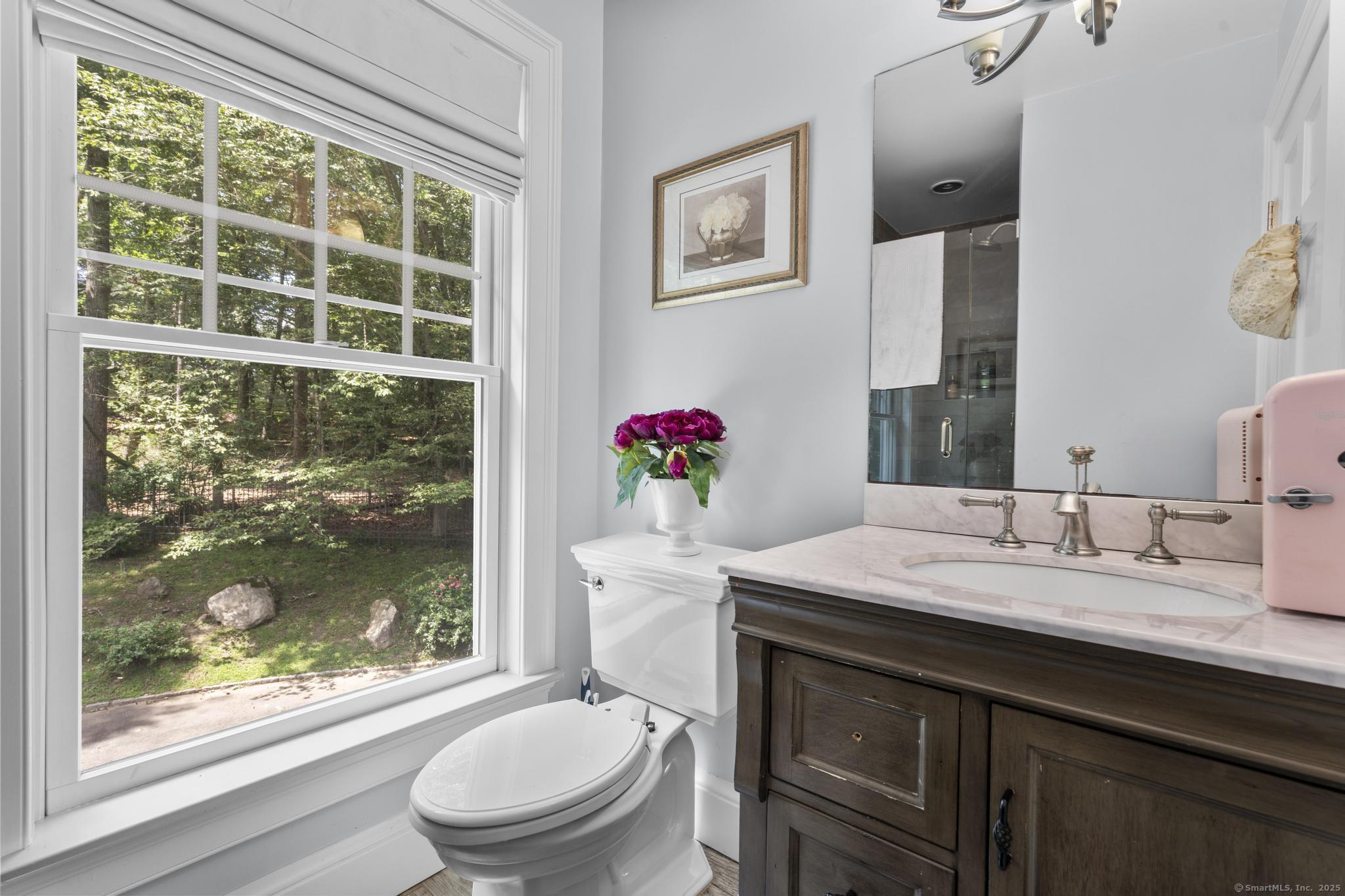 101 Brambly Hedge Circle Fairfield, CT 06824 - Photo 32 of 40 a bathroom with a granite countertop sink mirror vanity and toilet