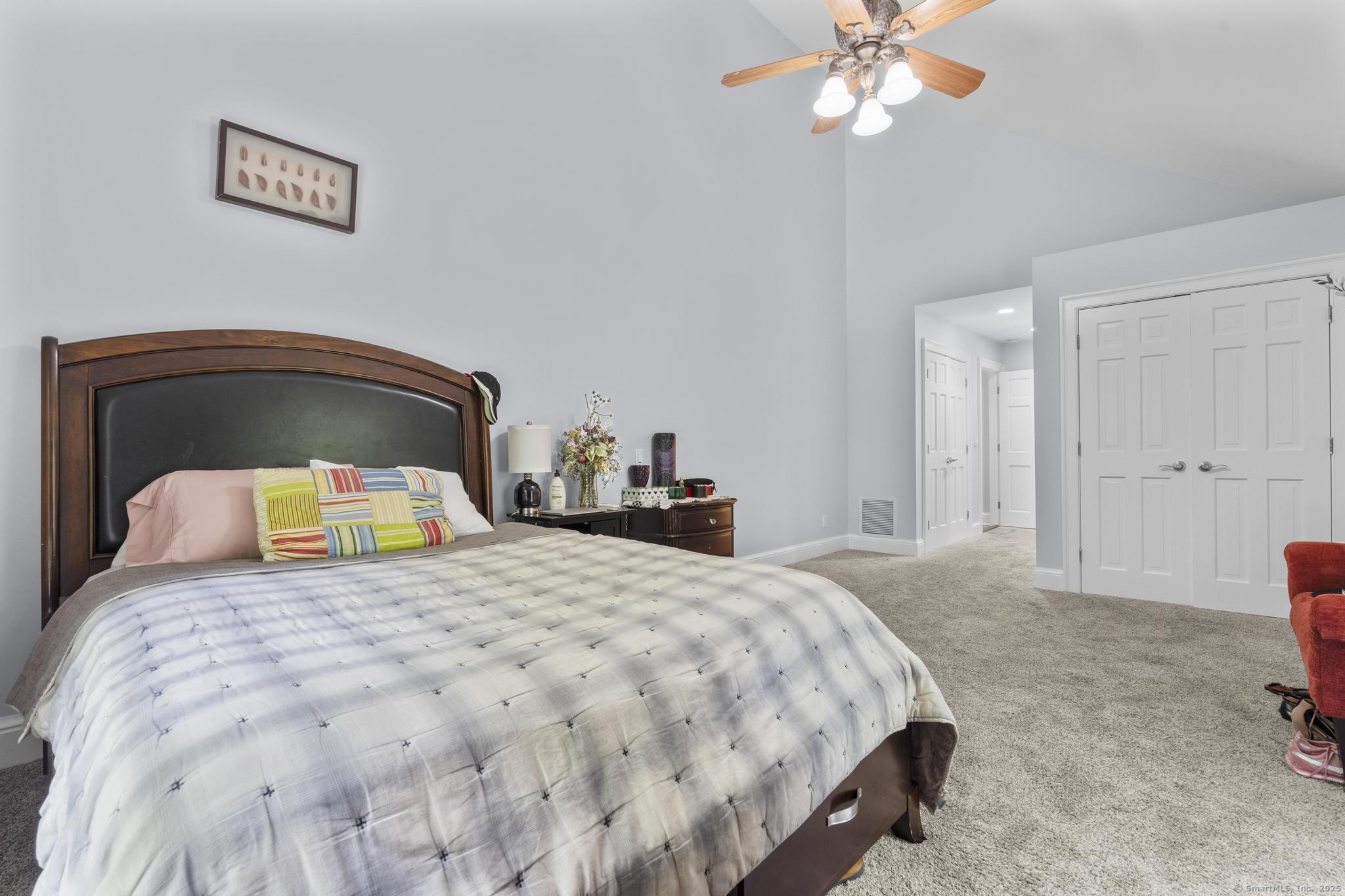 101 Brambly Hedge Circle Fairfield, CT 06824 - Photo 33 of 40 a bedroom with a bed and a chandelier