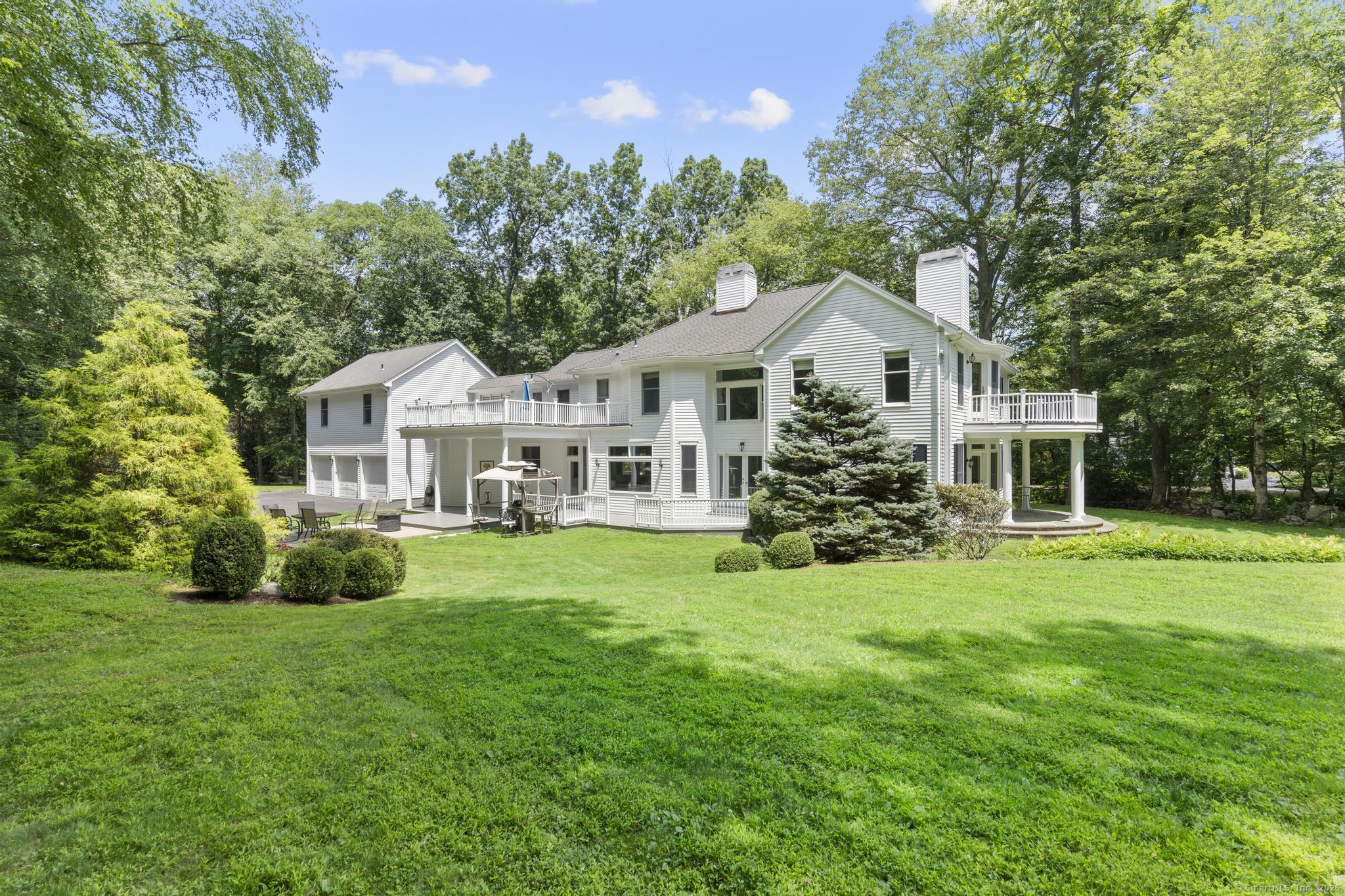 101 Brambly Hedge Circle Fairfield, CT 06824 - Photo 38 of 40 a front view of a house with a garden and trees