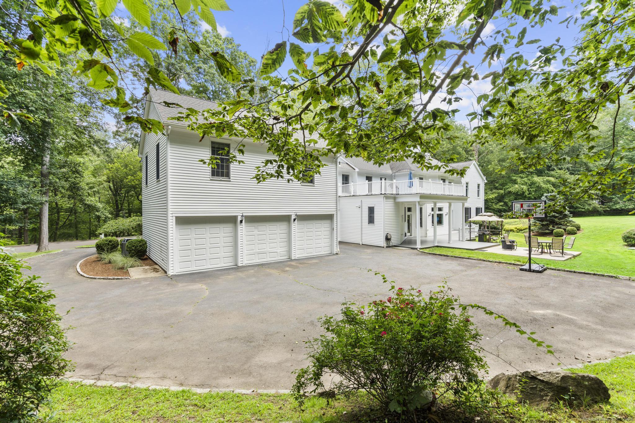 101 Brambly Hedge Circle Fairfield, CT 06824 - Photo 39 of 40 front view of a house with a yard and potted plants