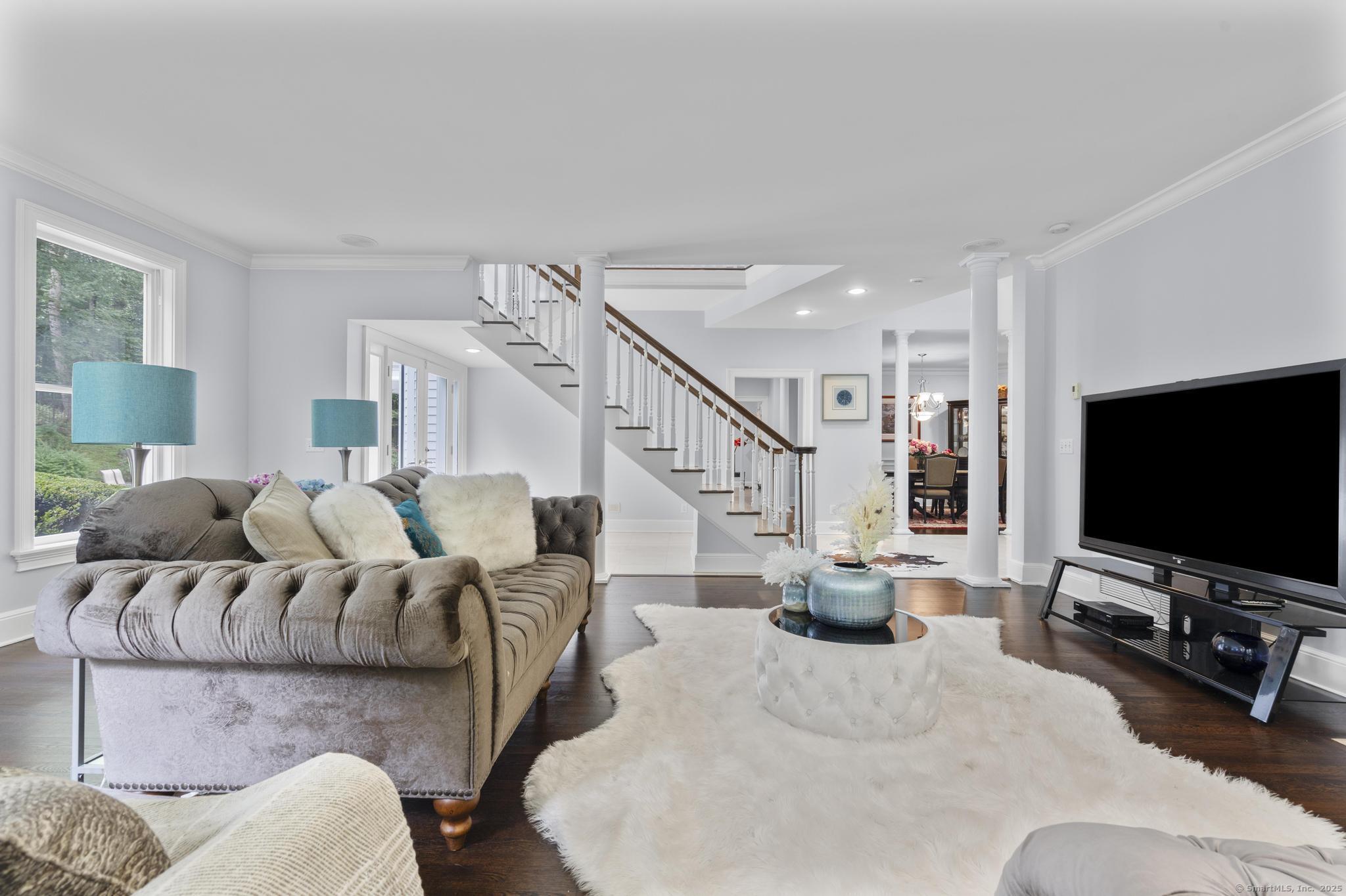 101 Brambly Hedge Circle Fairfield, CT 06824 - Photo 8 of 40 a living room with furniture and a flat screen tv