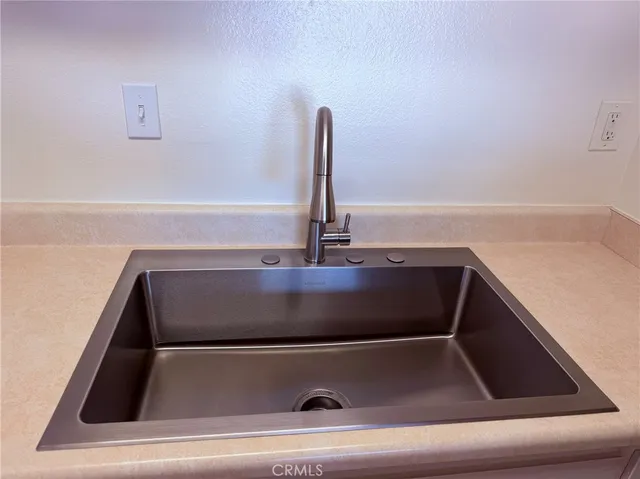 a kitchen with a sink and stainless steel appliances