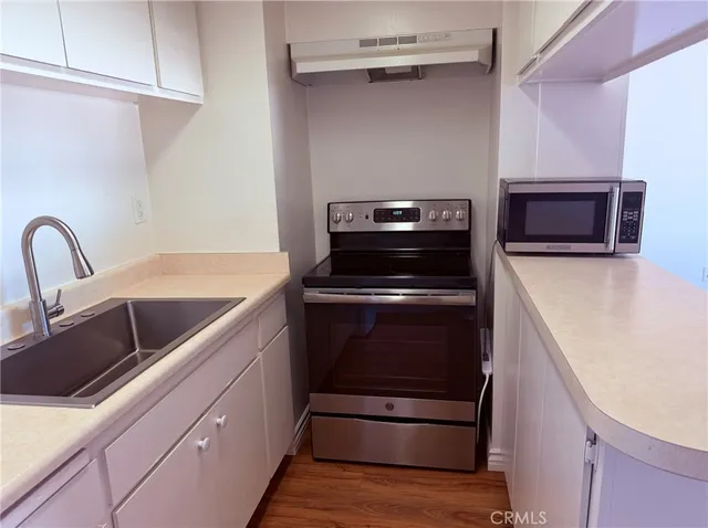 a kitchen with cabinets and white appliances
