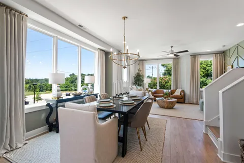 a view of a dining room and hall with furniture window
