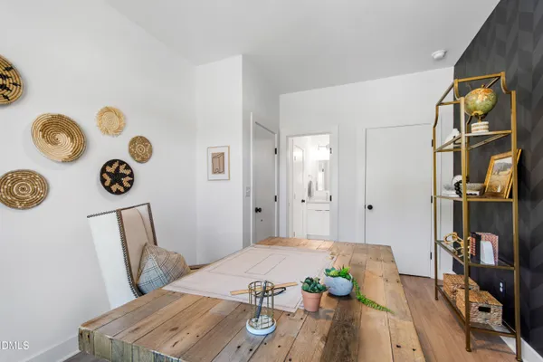a view of a dining room with furniture a chandelier and wooden floor