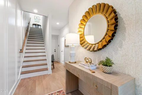 a kitchen with a sink a counter top space stainless steel appliances a stove and a window