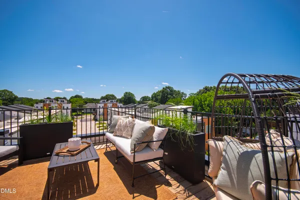 a view of a house with a yard and potted plants