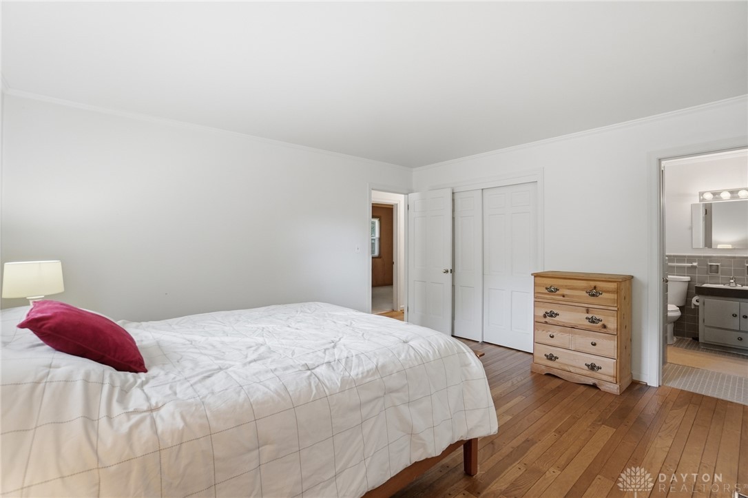 6119 Flemington Road Dayton, OH 45459 - Photo 26 of 76 This spacious bedroom offers gleaming hardwood floors and ample closet space, with convenient bathroom access.