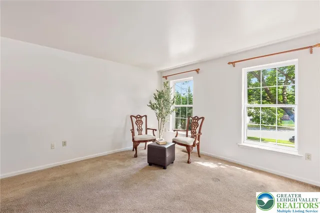 a view of a room with furniture and windows