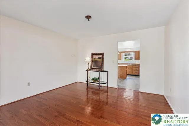 a living room with hard wood floors and a ceiling fan