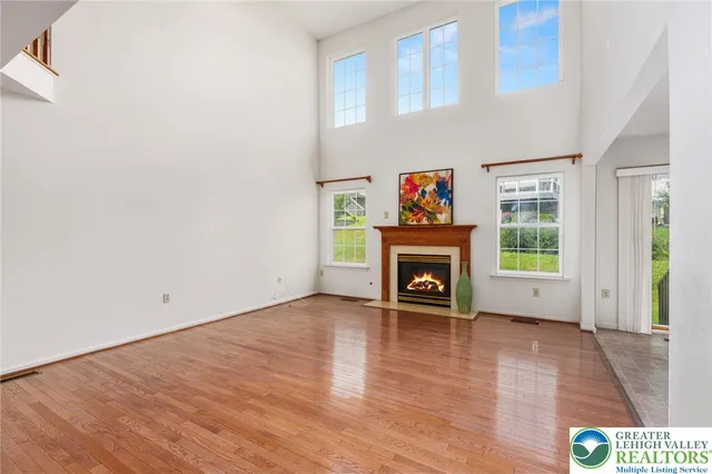 a view of an empty room with a fireplace and a window