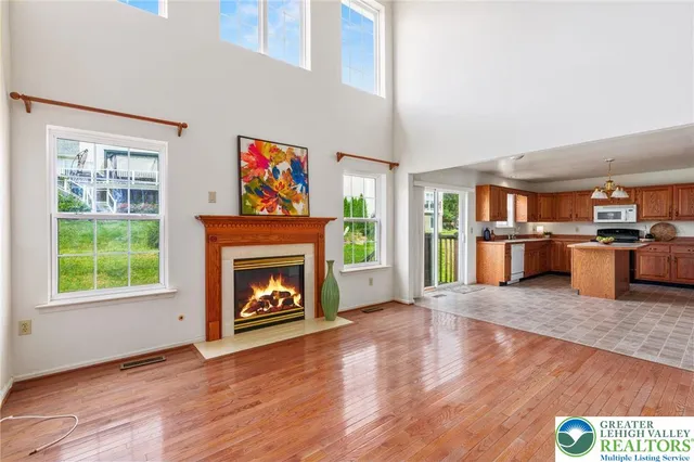 a view of a livingroom with wooden floor and a fireplace