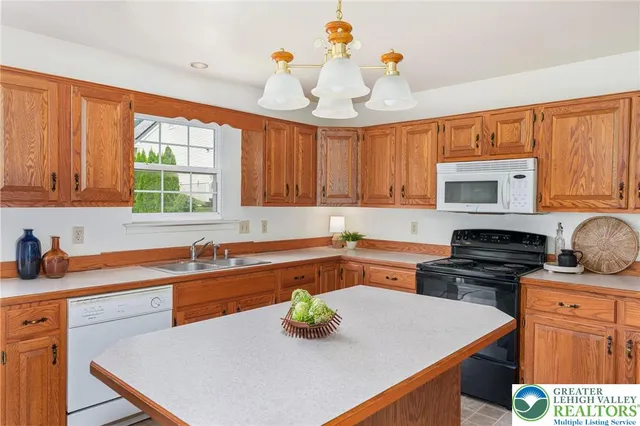 a kitchen with stainless steel appliances a stove a sink and a refrigerator