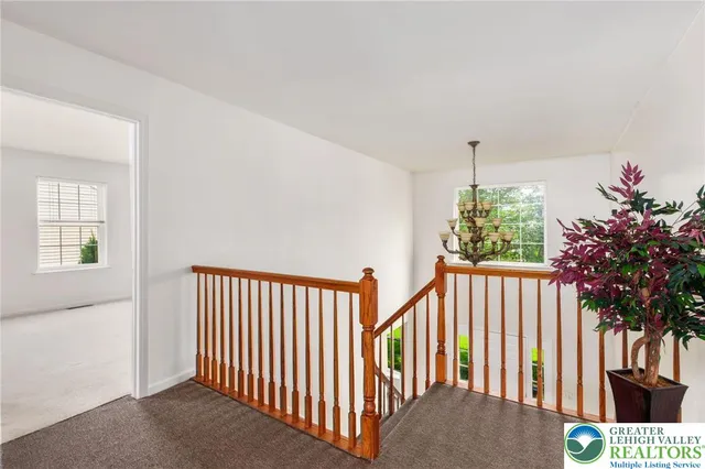 a view of hallway with wooden floor