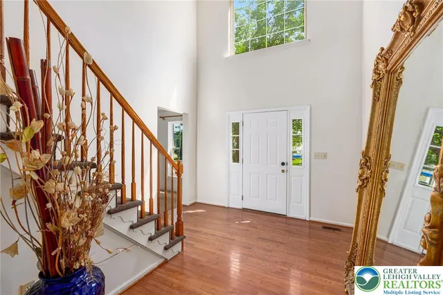 a view of an entryway with wooden floor and stairs