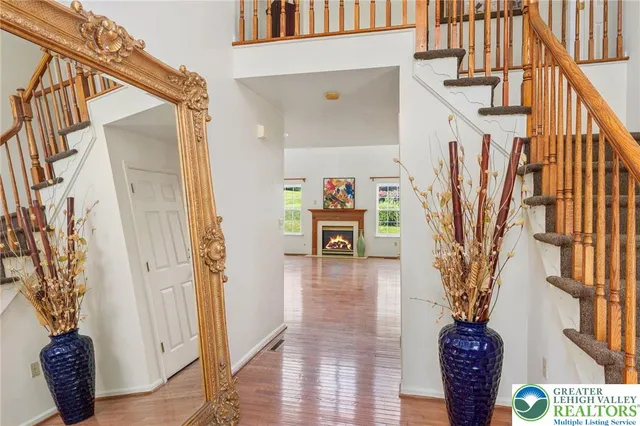 a view of entryway and hall with wooden floor