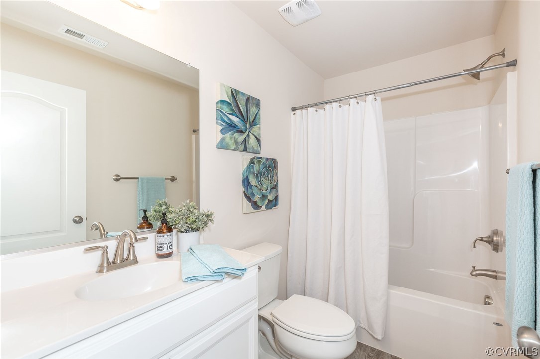 12107 Perdue Springs Loop Chester, VA 23831 - Photo 23 of 26 a bathroom with a sink a toilet a tub and shower