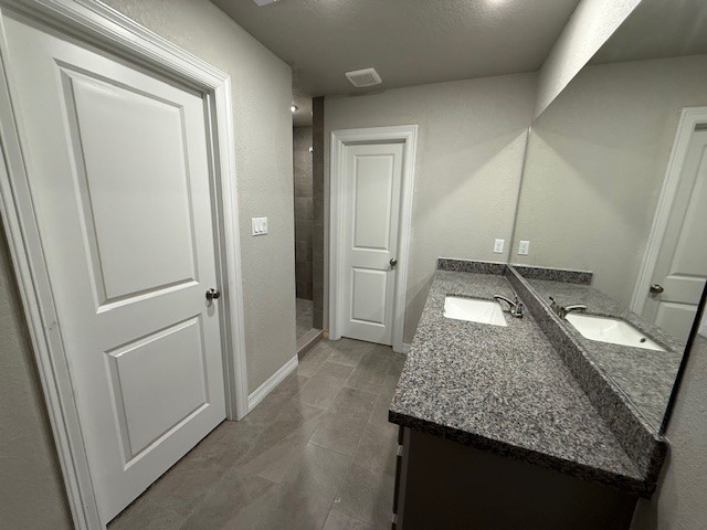 1031 South Anderson Street Angleton, TX 77515 - Photo 12 of 20 a kitchen with a granite countertop sink and refrigerator
