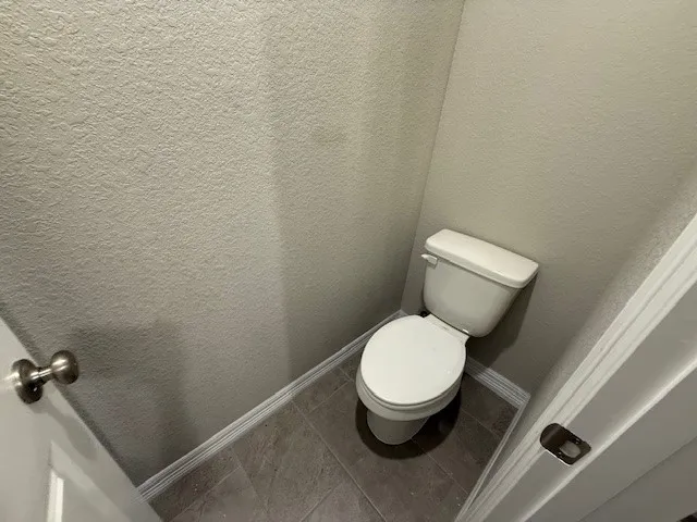 a white toilet sitting next to a sink