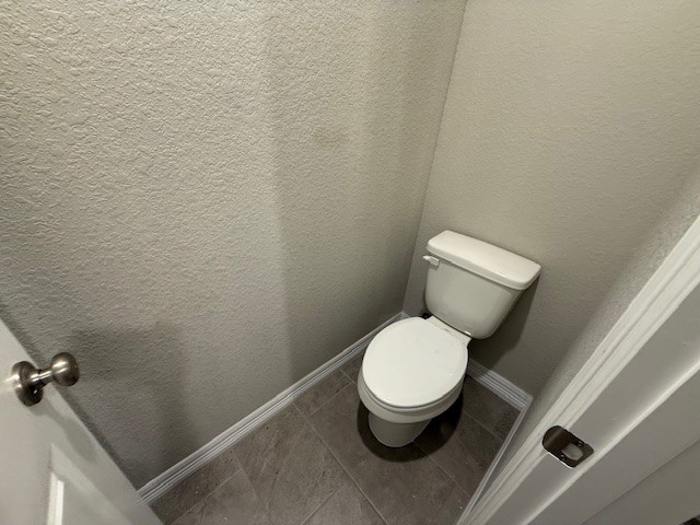 1031 South Anderson Street Angleton, TX 77515 - Photo 13 of 20 a white toilet sitting next to a sink