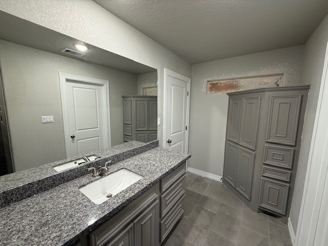 1031 South Anderson Street Angleton, TX 77515 - Photo 15 of 20 a bathroom with a granite countertop sink and a mirror