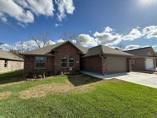 a front view of a house with a yard and garage
