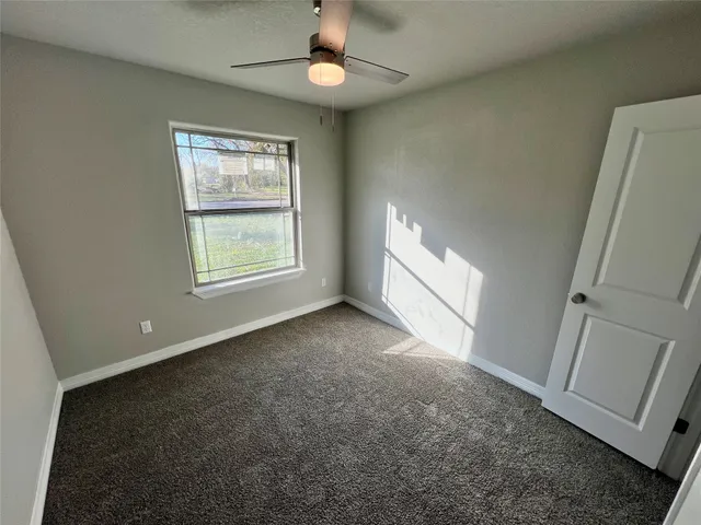an empty room with windows and entrance