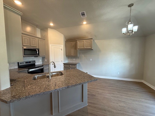 1031 South Anderson Street Angleton, TX 77515 - Photo 4 of 20 a kitchen with kitchen island granite countertop a sink a counter space appliances and cabinets
