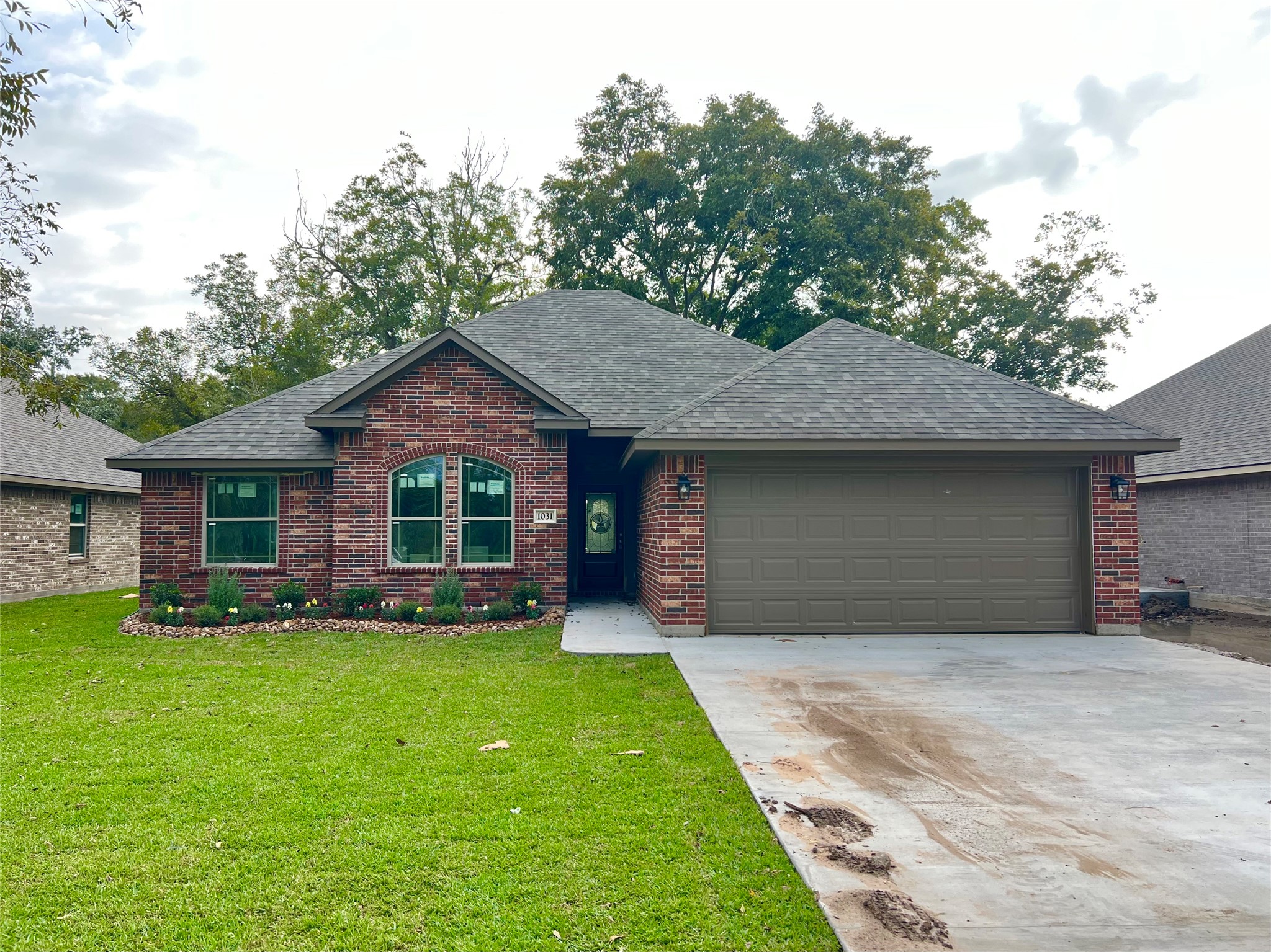 1031 South Anderson Street Angleton, TX 77515 - Photo 6 of 6 a front view of a house with a yard and garage