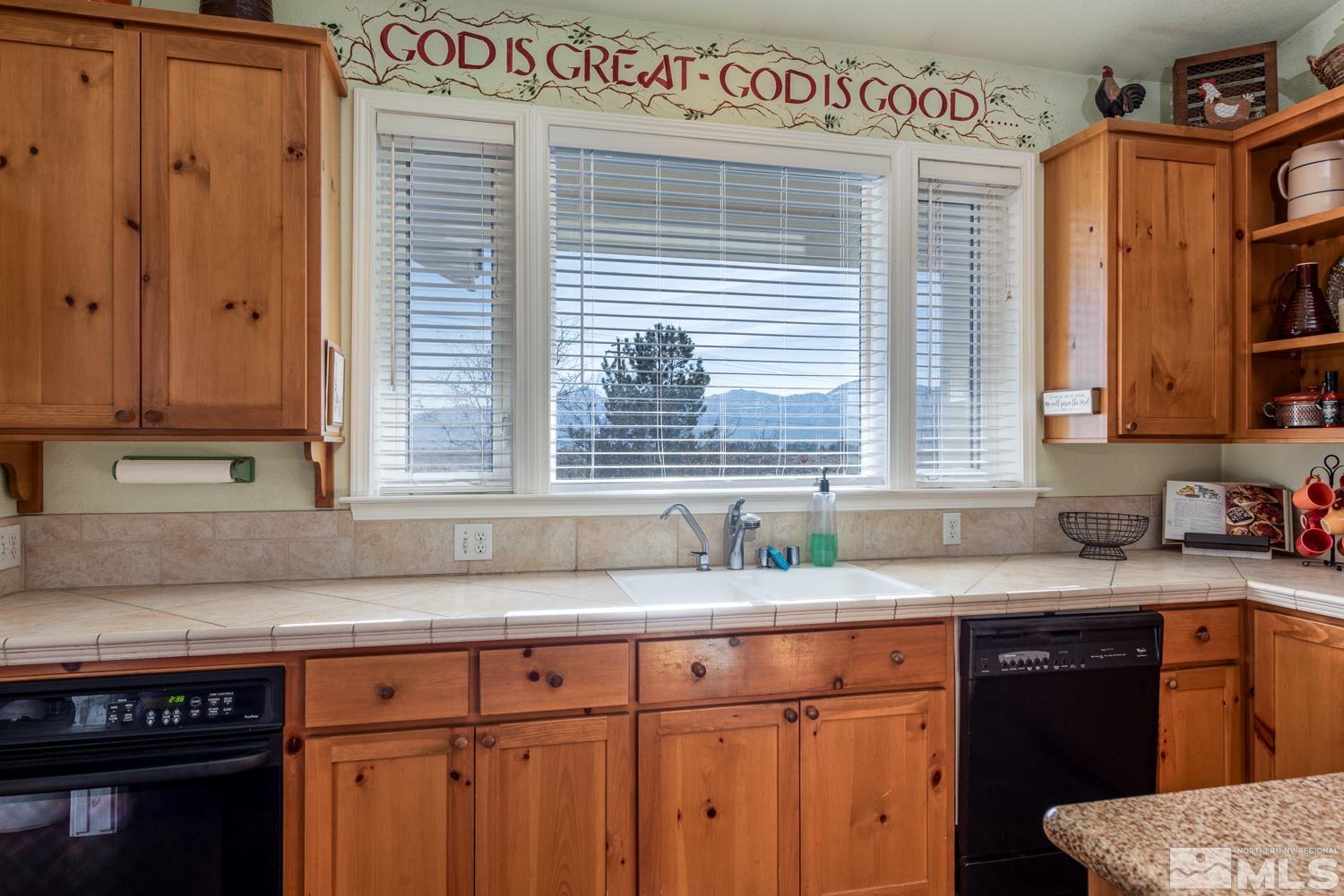 1480 Johnson Lane Minden, NV 89423 - Photo 8 of 31 a kitchen with granite countertop a sink a stove and cabinets