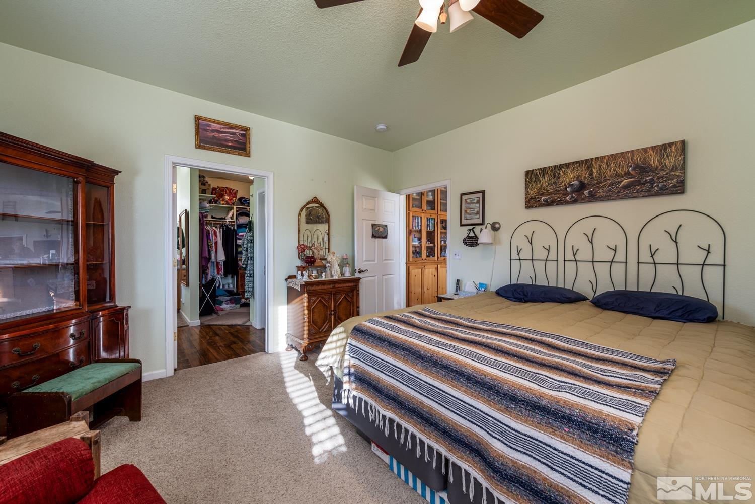 1480 Johnson Lane Minden, NV 89423 - Photo 10 of 31 a bedroom with furniture and a chandelier