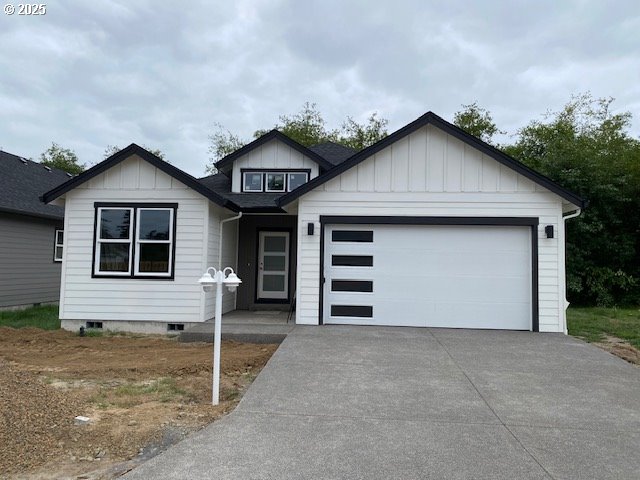 11645 Sawgrass Place Nehalem, OR 97131 - Photo 14 of 40 a front view of a house with a yard and garage