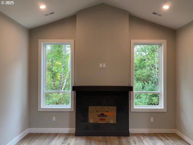 11645 Sawgrass Place Nehalem, OR 97131 - Photo 4 of 40 a living room with a fireplace and a window