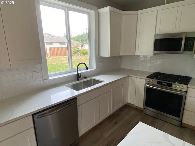 11645 Sawgrass Place Nehalem, OR 97131 - Photo 7 of 40 a kitchen with stainless steel appliances a sink stove and microwave