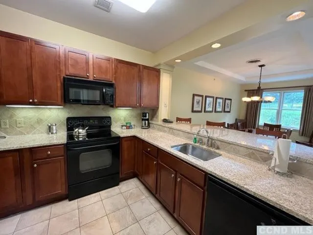 a kitchen with granite countertop a sink and cabinets