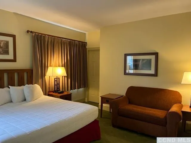 a bedroom with a bed couch and window