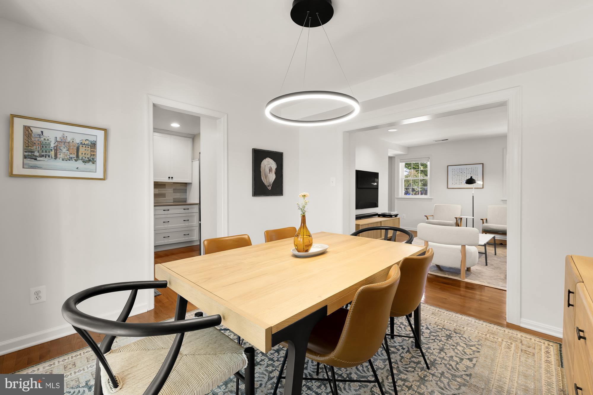 6723 Fairfax Road, Unit 15 Chevy Chase, MD 20815 - Photo 13 of 43 a view of a dining room with furniture and wooden floor