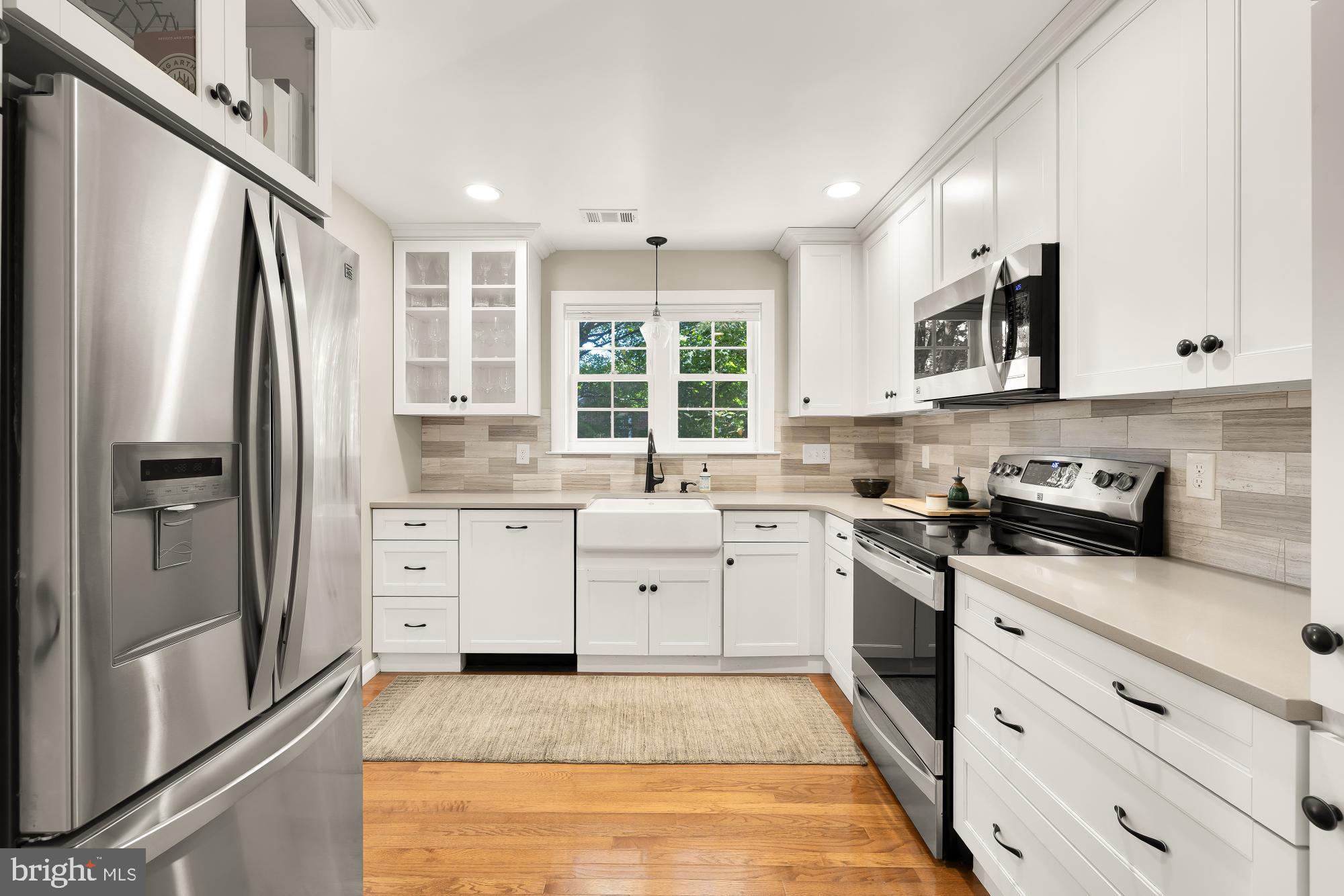 6723 Fairfax Road, Unit 15 Chevy Chase, MD 20815 - Photo 16 of 43 a kitchen with stainless steel appliances granite countertop a refrigerator sink and stove