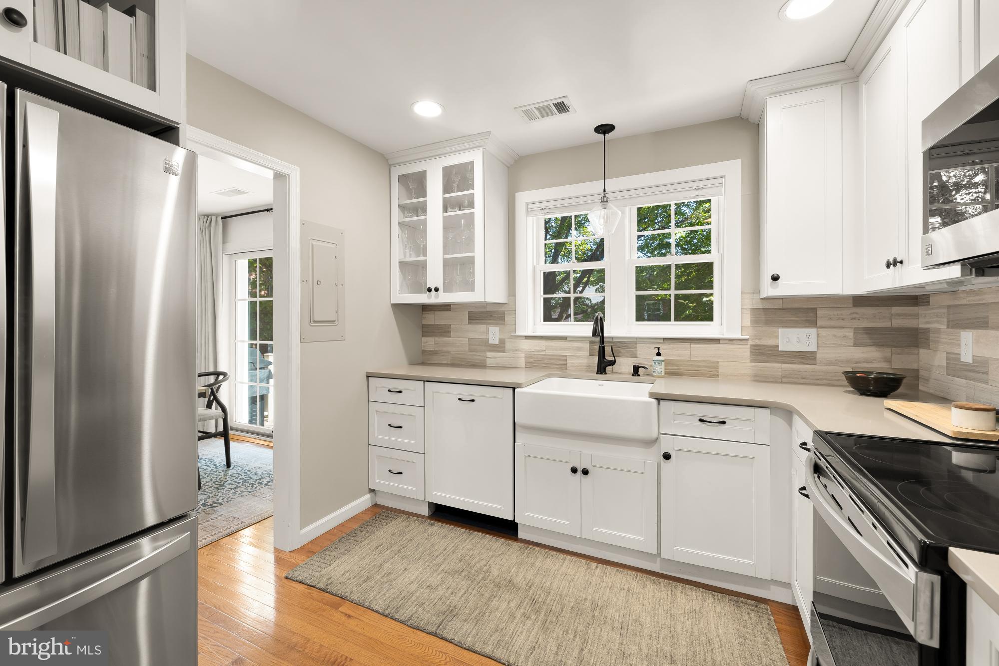 6723 Fairfax Road, Unit 15 Chevy Chase, MD 20815 - Photo 17 of 43 a kitchen with white cabinets and window