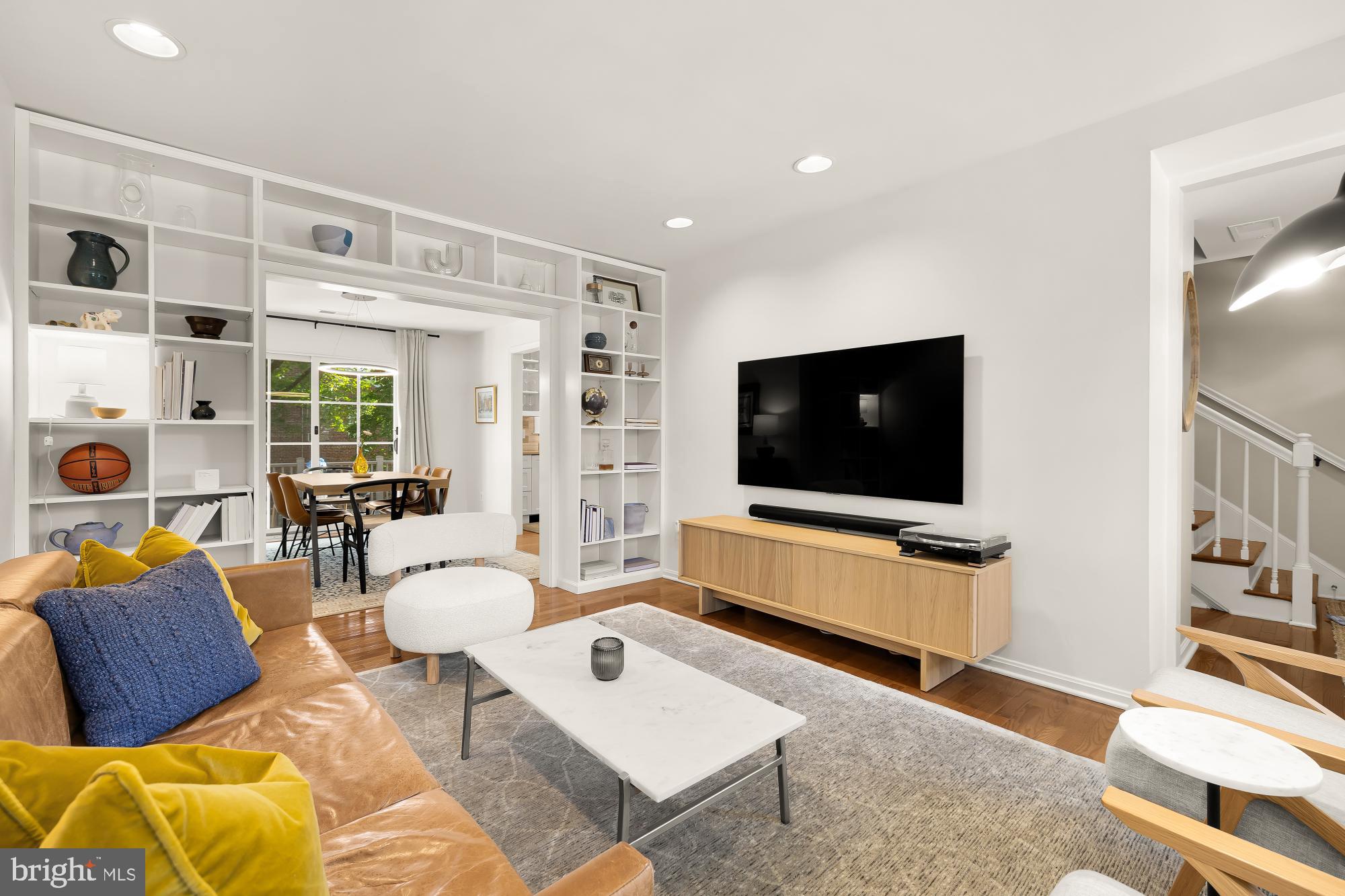 6723 Fairfax Road, Unit 15 Chevy Chase, MD 20815 - Photo 8 of 43 a living room with furniture and a flat screen tv
