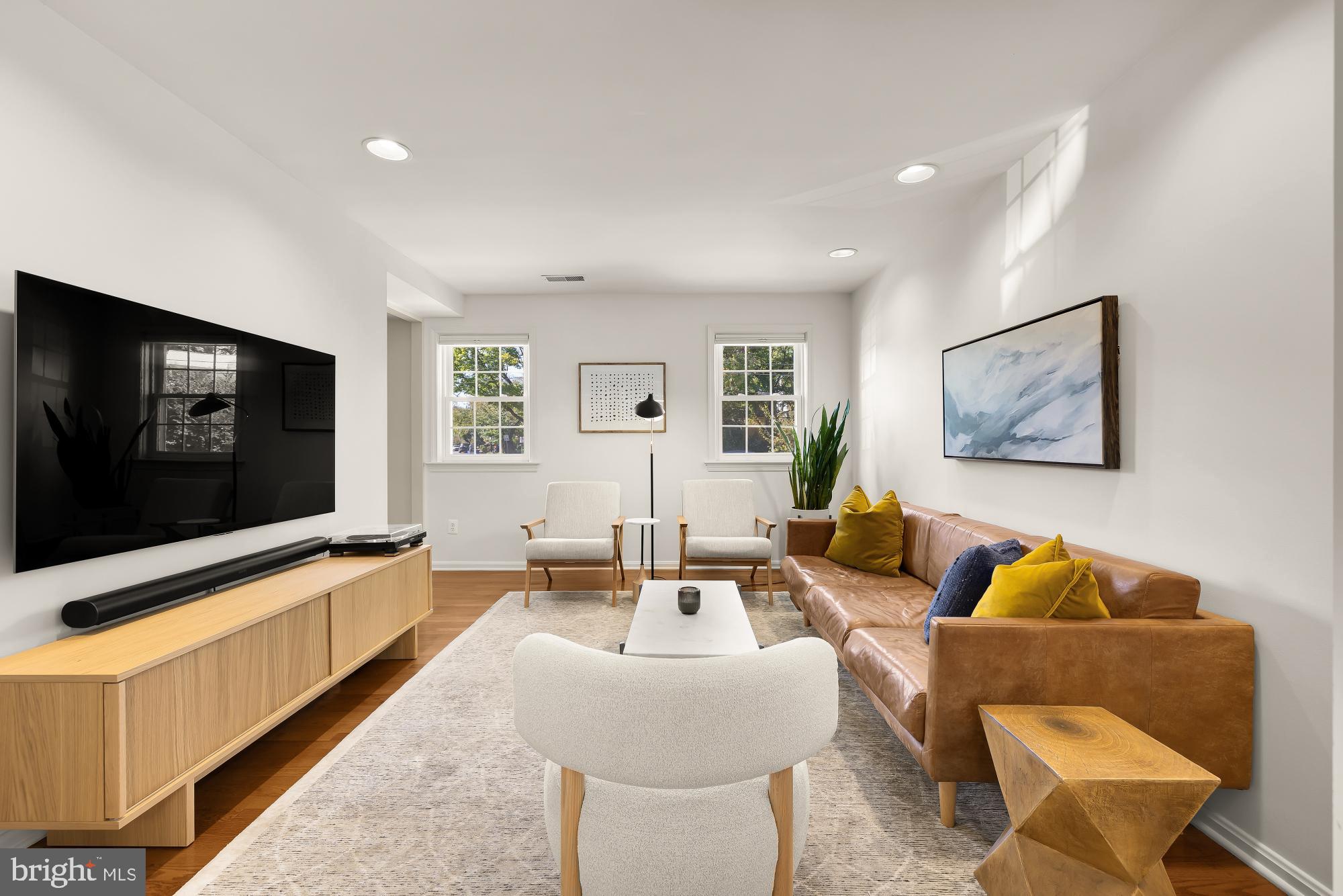 6723 Fairfax Road, Unit 15 Chevy Chase, MD 20815 - Photo 10 of 43 a living room with furniture and a flat screen tv