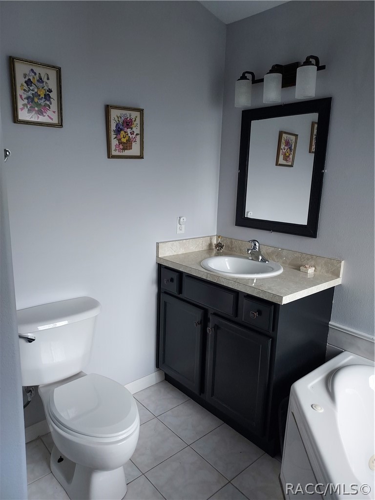 9306 East Gospel Island Road Inverness, FL 34450 - Photo 16 of 16 a bathroom with a toilet sink and mirror