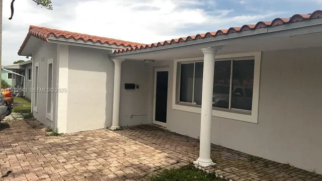 a view of a house with wooden walls