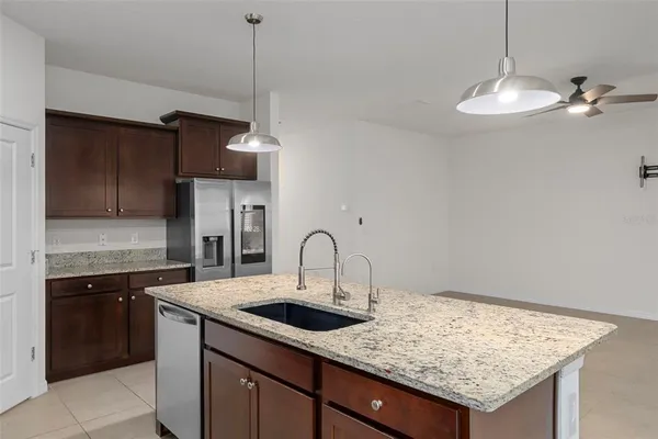 a kitchen with a sink a counter space cabinets and appliances