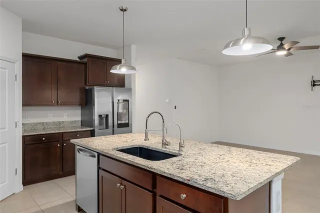 a kitchen with a sink a counter space cabinets and appliances